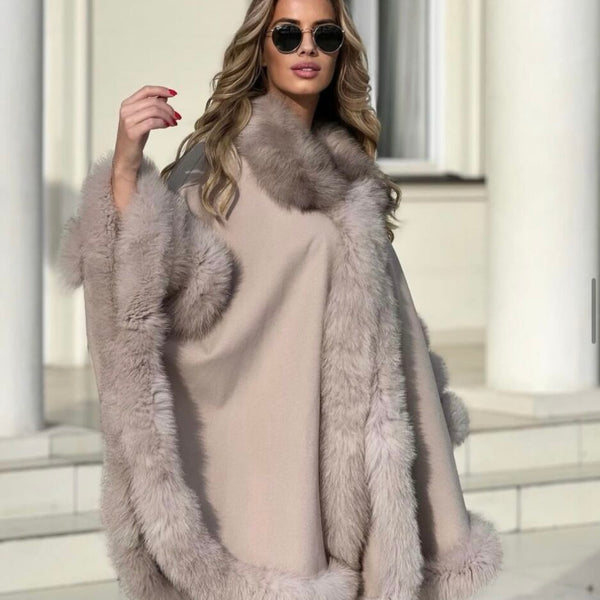 Woman wearing a fur coat and sunglasses outdoors.