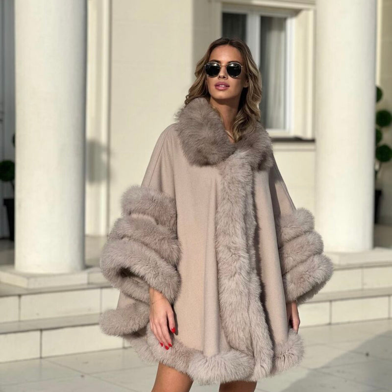 Woman wearing a fur-trimmed coat in front of classical architecture