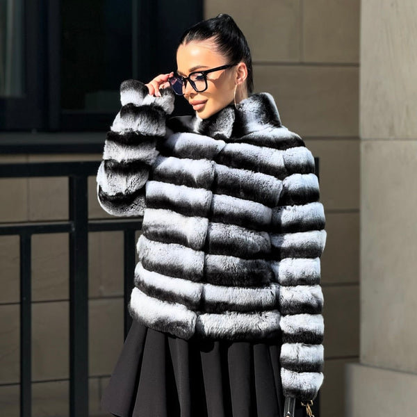 Woman wearing a striped fur coat in an urban setting