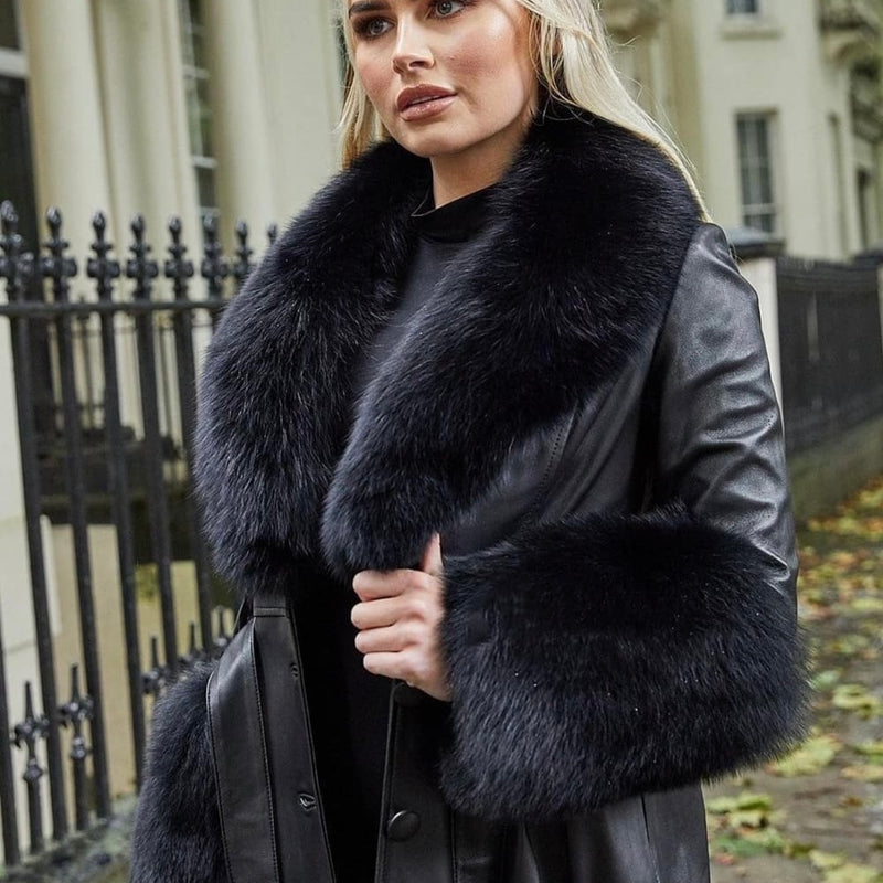 Woman wearing a black leather coat with fur collar in an urban setting