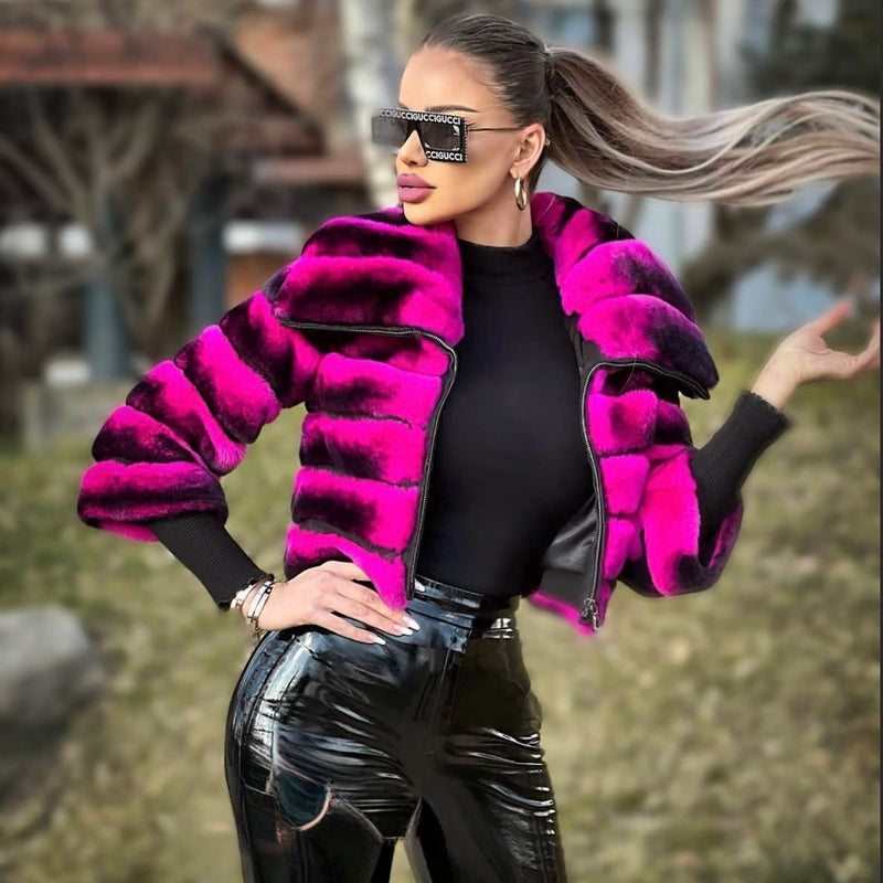 Person wearing a bright pink and black fur coat with a blurred outdoor background