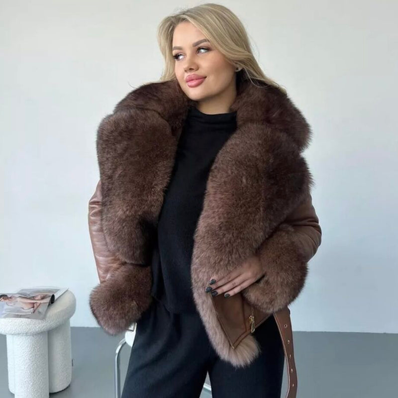 Woman wearing a brown fur coat against a plain background